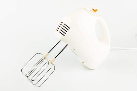 white electric food mixer with beaters on white tableの写真素材