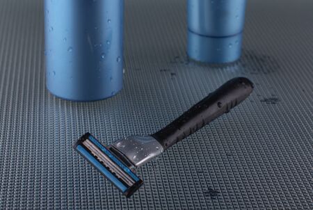Foam for shaving, a cream after shaving on dark blue background