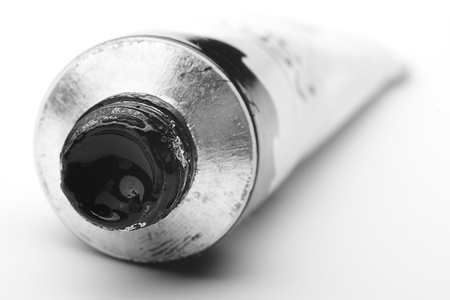 a tube of paint black color on white backgroundの写真素材