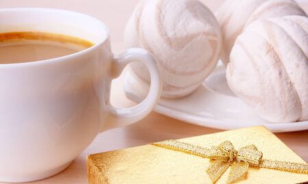 The Giftbox And Cup Of Coffee In Wood Surfaceの写真素材