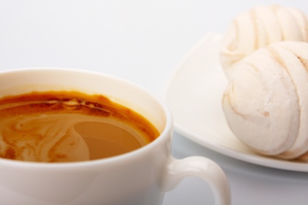 Cup of coffee and cakes on whiteの写真素材