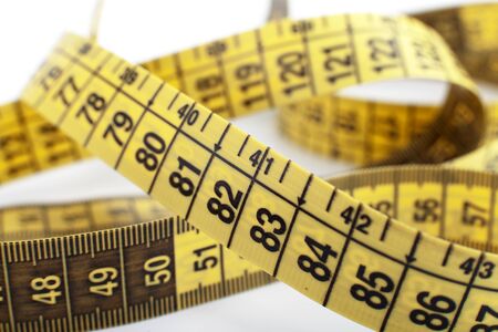 yellow tape measure on the white background