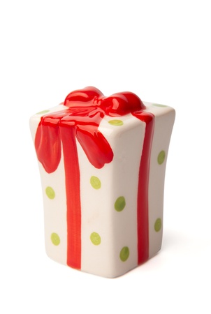 A white ceramic christmas present with red bow. Isolated on a white backgroundの写真素材