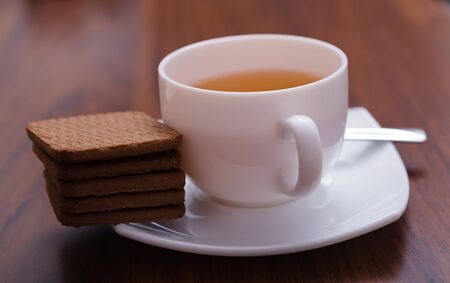 cup of tea and cookies on the wooden tableの写真素材
