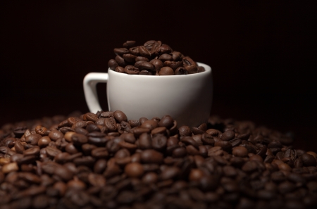 cup with coffee beans on a dark backgroundの写真素材