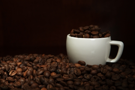 cup with coffee beans on a dark backgroundの写真素材