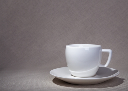 the cup and saucer on a natural fabricの写真素材