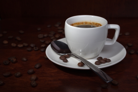 cup with coffee beans on a dark backgroundの写真素材