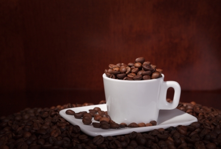 cup with coffee beans on a dark backgroundの写真素材