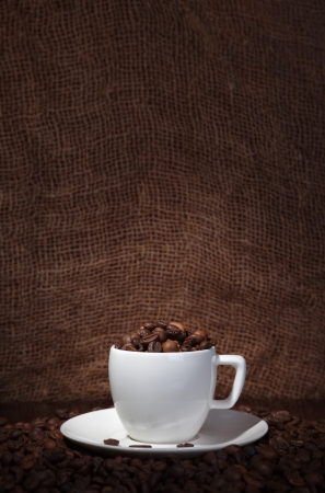 cup with coffee beans on a dark backgroundの写真素材
