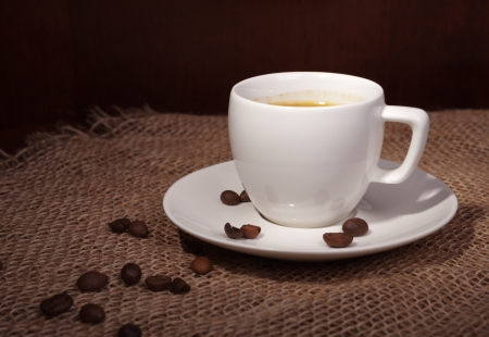 cup with coffee beans on a dark backgroundの写真素材