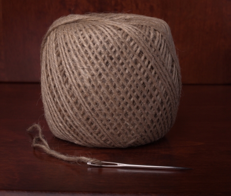 Natural Clew of Twine and Needle on the Wooden Backgroundの写真素材