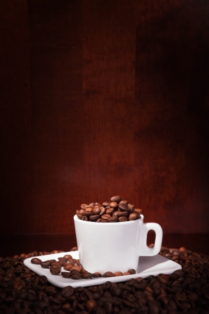 cup with coffee beans on a dark backgroundの写真素材