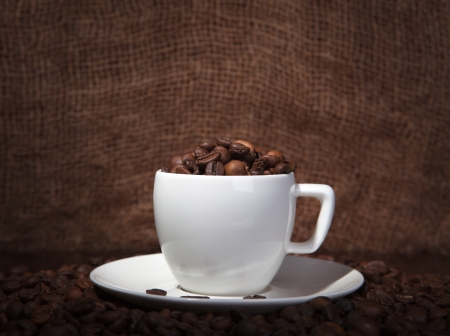 cup with coffee beans on a dark backgroundの写真素材