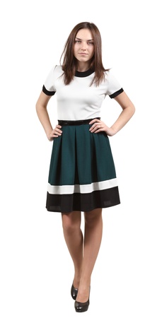 Photo of a young woman in the dress, standing against a white backdropの写真素材
