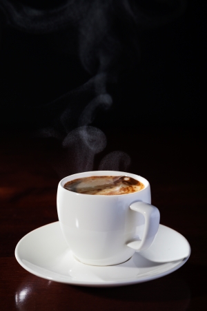 hot cup of fragrant coffee on a wooden tableの写真素材
