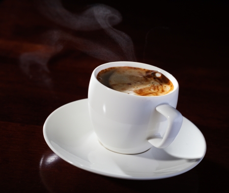 hot cup of fragrant coffee on a wooden tableの写真素材