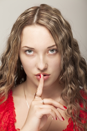 Young sexy woman gesturing for being quietの写真素材
