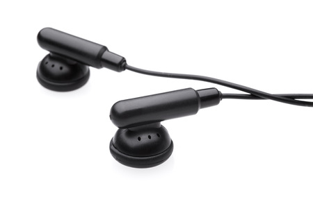 black earbuds on white background with shadowの写真素材