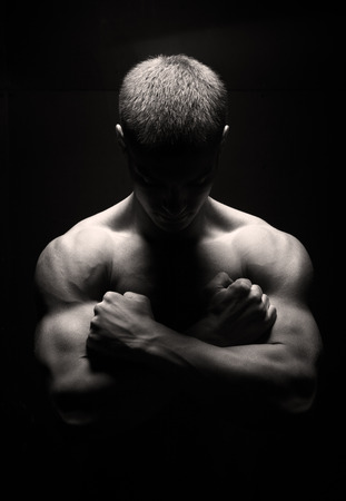 the muscular man's back  on black backgroundの写真素材