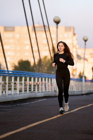 beautiful sports girl runs with a smile on his faceの写真素材