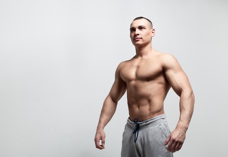 Handsome strong athletic man. Bodybuilder with perfect abs, shoulders, biceps, triceps and chest.の写真素材