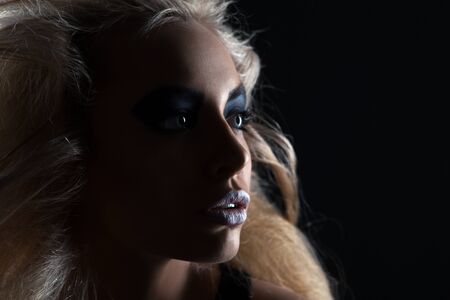 Closeup portrait of a serious lady with smoky eye makeupの写真素材