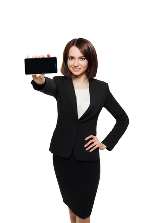 Business woman show blank card or mobile cell phone display on a white background. Focus on the handの写真素材