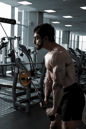 Young Bodybuilder Doing Heavy Weight Exercise For Tricepsの写真素材