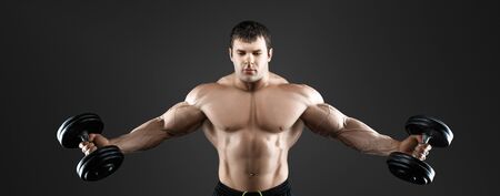 Portrait of bodybuilder with dumbbellsの写真素材