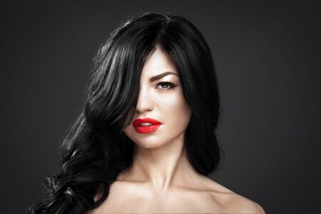 Beautiful brunette woman with shot hairstyle and sexy red lips.の写真素材