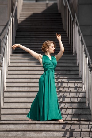 Beautiful girl dancing in the city.の写真素材