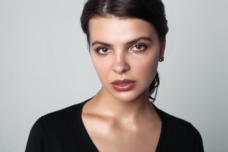 Portrait of beautiful female model on gray backgroundの写真素材