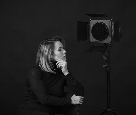 Dramatic black and white portrait of a beautiful woman on a dark background