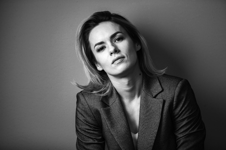 Dramatic black and white portrait of a beautiful woman on a dark backgroundの写真素材