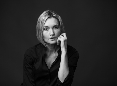 Dramatic black and white portrait of a beautiful woman on a dark backgroundの写真素材