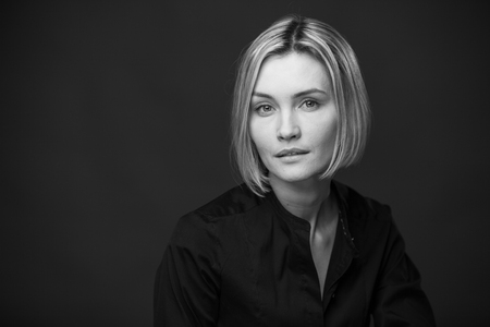 Dramatic black and white portrait of a beautiful woman on a dark backgroundの写真素材