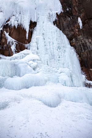 Frozen ice on rocks from a waterfall in the mountainsの写真素材