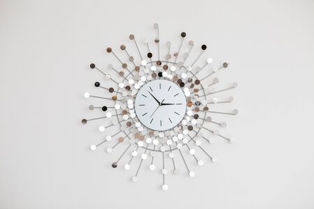 Hours of an interesting form hang on wallの写真素材