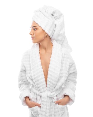 Young woman in a bathrobe and towel on her headの写真素材