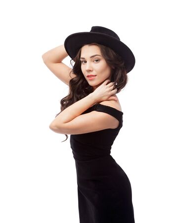 Portrait of a beautiful lady wearing a black hat and evening dressの写真素材