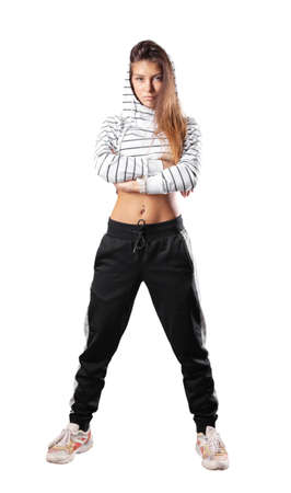 A slender girl stands with her arms crossed on her chestの写真素材