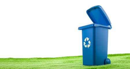 Plastic blue container stands on green grass against white background.の写真素材