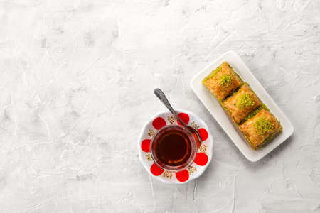BAKLAVA. Traditional Turkish Desserts Baklava with Turkish Tea. Top view. Crispy pistachio baklava...
