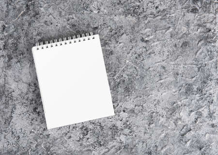 White blank paper desk spiral calendar on gray texture background.の写真素材