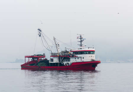 ISTANBUL, TURKEY - FEBRUARY 5, 2021: Fishing boat at work on Marmara Sea in Istanbul Bosphorus. Turkey.のeditorial素材