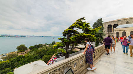 ISTANBUL - AUGUST 15, 2019: Tourists on the Garden of Topkapi Palace with bosphorus view. ISTANBUL...