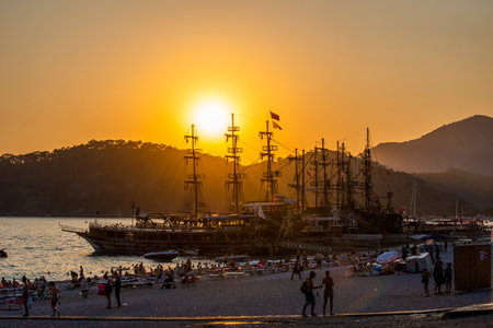 FETHIYE, MUGLA, TURKEY - August 21, 2021: Sunset view on OLUDENIZ, FETHIYE. Tour boats on sunset. Very beautiful touristic destination. Oludeniz - Fethiye, Mugla, Turkey.のeditorial素材