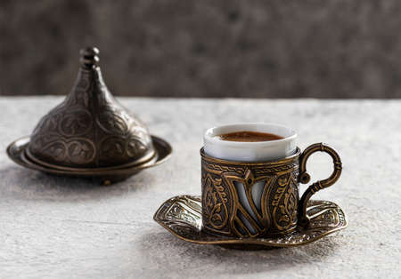 Turkish coffee in traditional copper cup on gray background.の写真素材