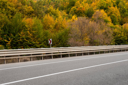 Highway and autumn landscape with vibrant fall colors. Empty mountain road in Turkey.の写真素材